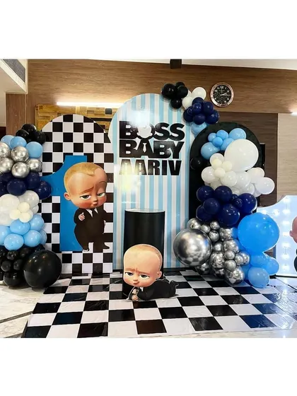 A stylish Boss Baby theme with a checkered floor and backdrop, combined with blue, black, and silver balloons for a modern look.