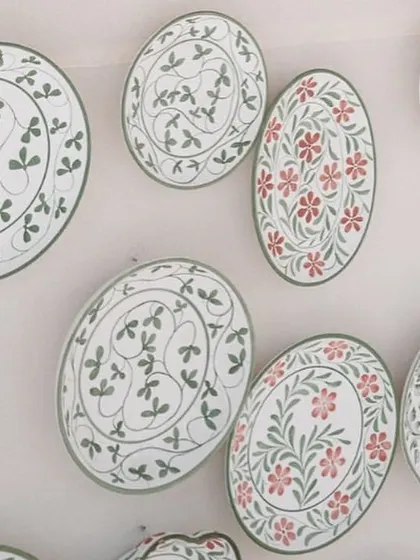 A close-up of the hand-painted ceramic plates used to decorate the bar. These bespoke details are what make a wedding truly one-of-a-kind.