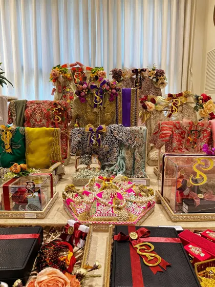 A breathtaking display of a complete bridal trousseau. Each tray tells a part of the bride's story, from her designer ensembles to her precious jewelry and accessories.