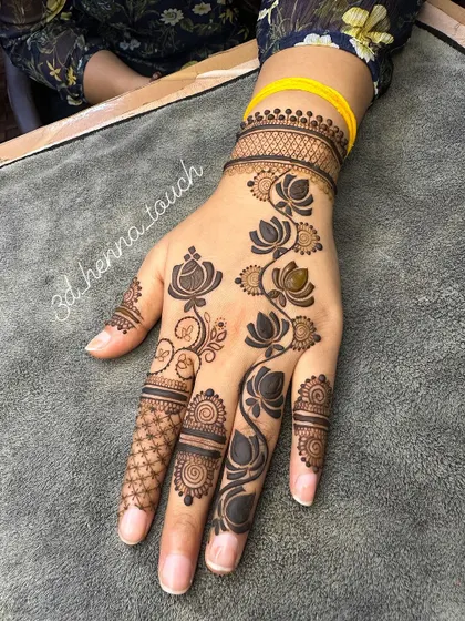 The bold lotus vine design, perfect for making a statement. The contrast between the dark flowers and the skin is beautiful.