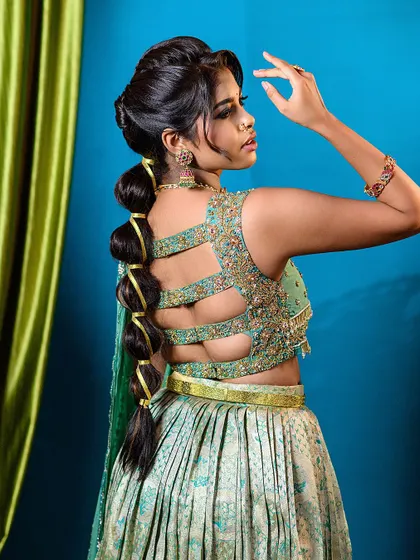 This shot highlights the unique back design of the blouse and the elegant bubble braid, showing how every angle is picture-perfect.