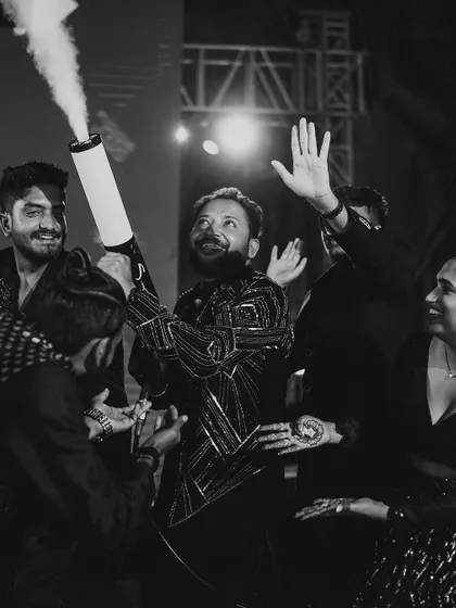 The groom makes a grand entrance at the Sangeet party with a CO2 cannon. It's all about creating high-energy, surprising moments that get the party started.