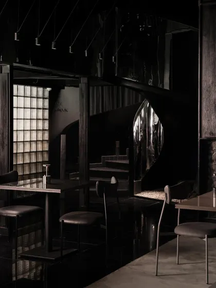 Inside Lair, the design is a study in duality. This view shows the contrast between the polished, reflective surfaces and the raw, dark textures, creating a space that is both industrial and intimate.
