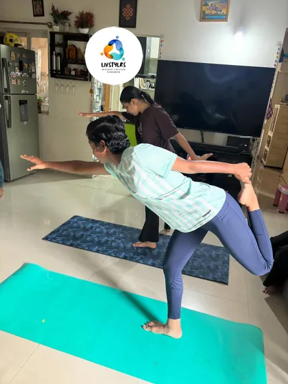A young client practices Natarajasana (Dancer's Pose), a beautiful balancing pose that improves focus, stability, and flexibility.