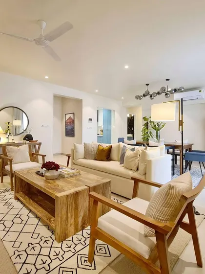 I love a long shot that gives you a sense of the overall space. From this corner of the Breeze Home living room, you can see glimpses of the dining area, the powder blue kitchen, and even the moody guest bathroom, showing how all the spaces flow together.