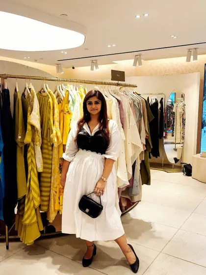 The full black and white ensemble, complete with a black handbag, showcasing a cohesive and powerful style story.