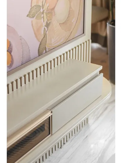 Detail of the TV console, which combines minimalist form with intricate fluted accents.