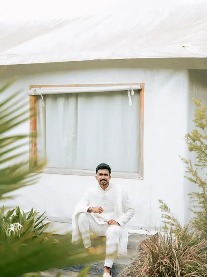 Another shot of Groom Sandesh, showcasing the elegance of our pre-loved white sherwani in a beautiful outdoor setting.