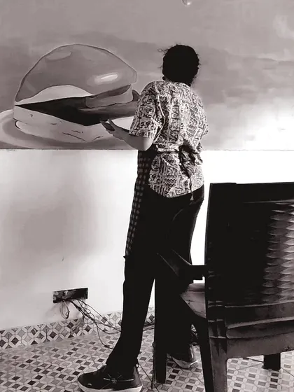 A duplicate image of me working on a food mural.