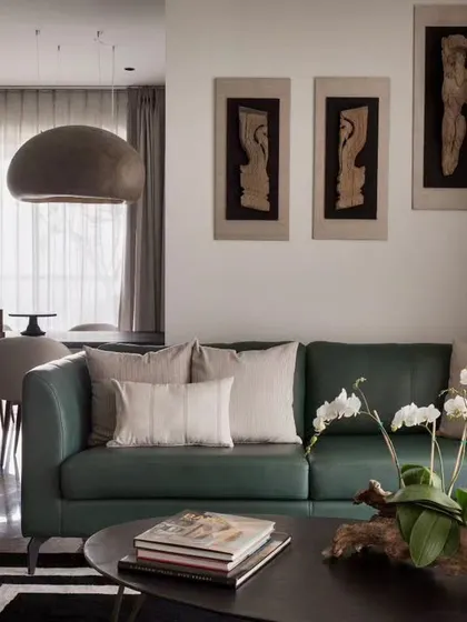 The heart of our Bengaluru high-rise project. We converted a four-bedroom layout into a spacious one-bedroom home with this expansive living and dining area, using a soothing palette of greens and neutrals.