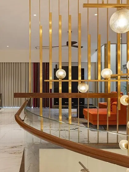 The Family Lounge furniture by WIBN. Celebrating the essence of this space's design! The chandelier continues to shine as the highlight on this floor, while the family lounge is adorned with a serene green onyx altar. A pop of joyful orange on the couch reflects the client's love for color, and don't forget to take in the allure of the stunning black and gold TV unit.