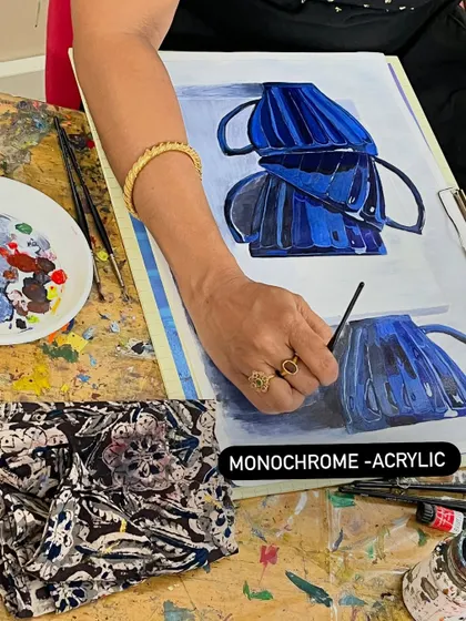 This monochrome study of stacked cups is a fantastic exercise in understanding value. By using only shades of blue, the student learns to see and paint light and shadow without relying on color.