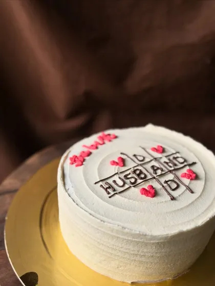 A sweet treat for a superhero dad and husband. This cake features a tic-tac-toe game where "Husband" and "Dad" are the winners, showing appreciation for all that he is.