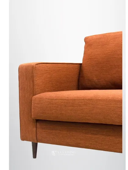 A close-up of the arm and fabric of our mid-century style sofa. The textured weave of the fabric adds depth, while the clean stitching highlights the quality of our craftsmanship.