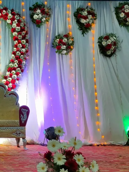 Another view of the stage featuring a heart-shaped floral arch.