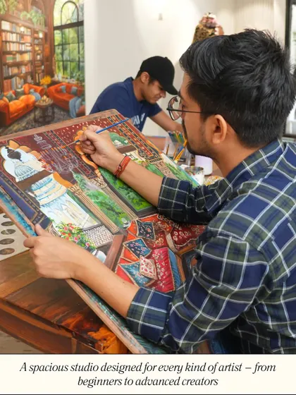 My spacious studio is designed for every kind of artist, from beginners to advanced creators. Here, two artists are deeply focused on their large-scale paintings.