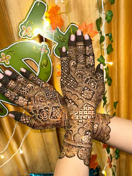 A beautiful and intricate design, perfect for a wedding guest or a festive occasion.