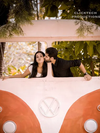 A fun and quirky shot of a couple posing with a vintage Volkswagen bus prop, perfect for a retro and lighthearted pre-wedding theme.