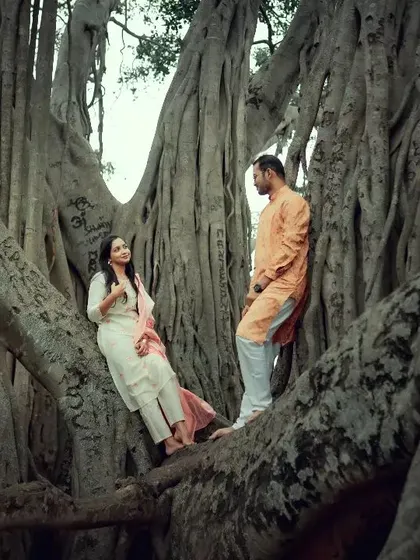 A romantic pose within the roots of a massive banyan tree, highlighting the scale of nature and the intimacy of the couple.