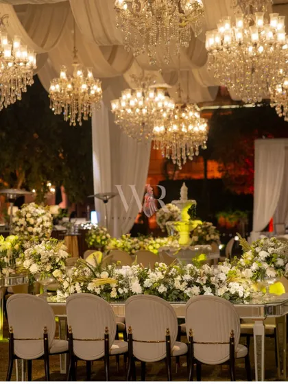 The head table at the ITC Grand Bharat, surrounded by a sea of white florals and glowing under a canopy of crystal chandeliers. This was our ode to grandeur for a destination wedding that demanded nothing less.