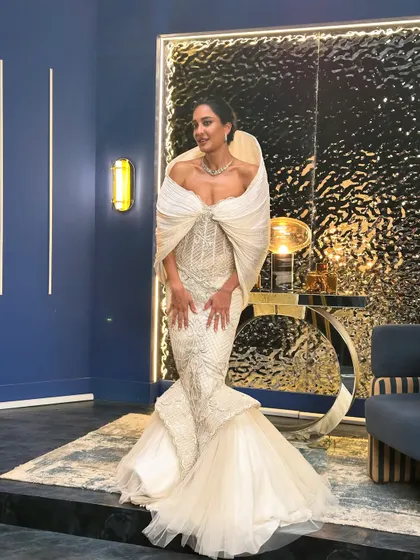 A full view of Lisa Haydon in the ivory gown, a silhouette that speaks in couture and a presence that stops time. This isn’t just a look, it’s a moment.