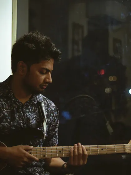 A bassist holding down the low end during a live artist session. The clear acoustics of our room ensure that every instrument in the band sounds tight and balanced.