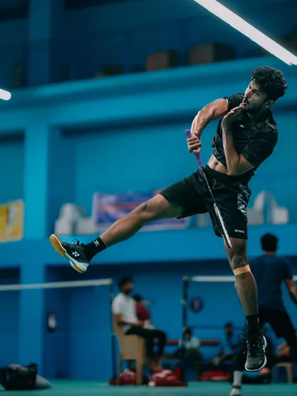 A full-extension jump smash. This dynamic shot captures the peak of athletic performance, a result of dedicated training and conditioning.