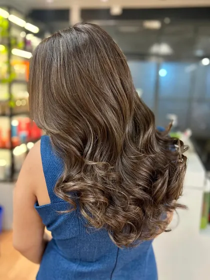 Ash brown is a cool, sophisticated choice. Here, the balayage technique creates a beautiful blend of ashy tones that look chic and modern.