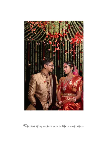 A classic portrait of the couple seated in the mandap, looking at each other with love.
