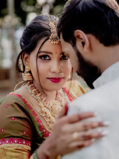 A powerful close-up where the bride looks directly at the camera. Her gaze is confident and captivating, drawing you into the emotion of the moment.