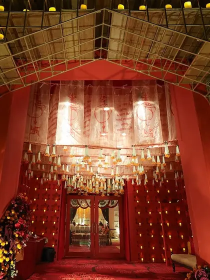 The entrance to the traditional event was a grand structure lined with a grid of hundreds of glowing candles, creating a breathtaking welcome.