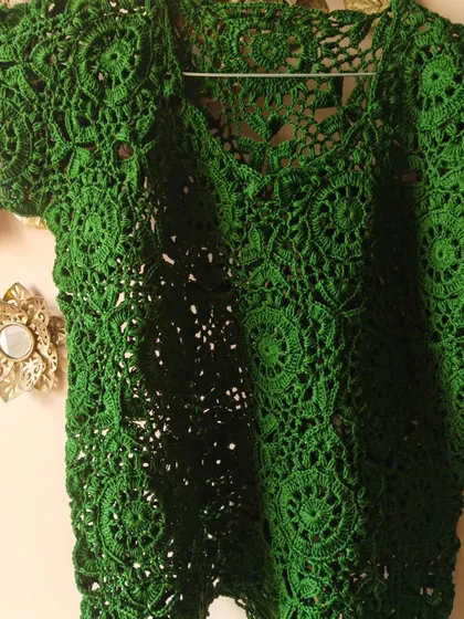 The texture and detail of the green lace top are what make it so special. Each circle motif is connected with care to create a seamless, flowing fabric.