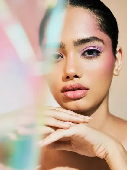 A creative shot that plays with light and reflection, showing how this makeup can transform in different settings.