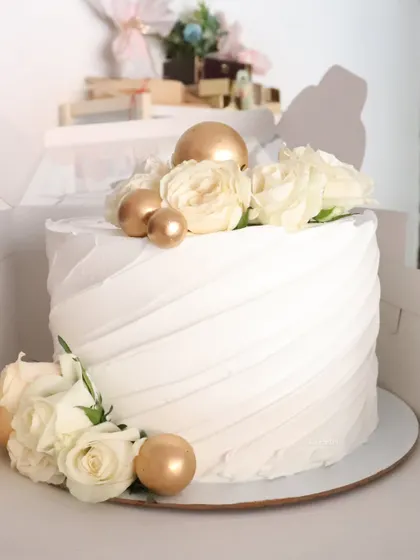 Another view of the elegant white and gold rose cake.