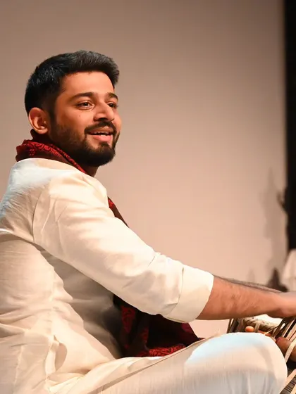 A candid shot of me during a musical performance. This captures the joy and focus I bring to my art, a quality I also channel into my modeling work.