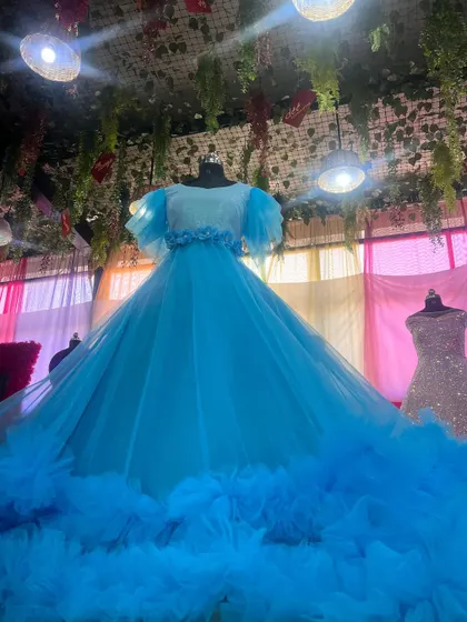 A low-angle shot showing the grand scale of our sky-blue ruffle gown.