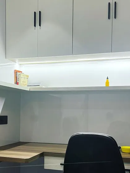 A closer look at the study desk, highlighting the bright, even task lighting from the integrated LED strip, which is essential for a productive workspace.