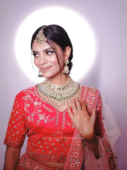 A smiling portrait in the pink lehenga, showing how confident and happy our outfits can make you feel.