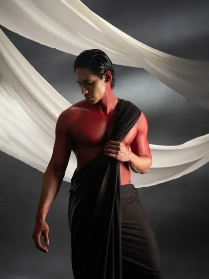 A portrait from the red body paint series, where the focus is on the smooth application of the paint and the way it accentuates the model's physique.