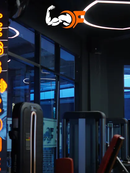 Another angle of our 'Legs Zone' with its distinctive neon sign. The modern lighting and premium equipment create an energizing atmosphere for every workout.