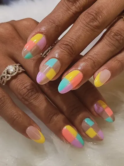 I'm obsessed with these pastel color block nails. The checkerboard pattern in soft shades of yellow, pink, purple, and blue creates a fun, geometric look on long almond nails.