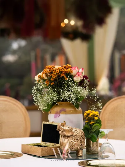 A centerpiece that beautifully blends boho style with Indian heritage. A brass elephant, a symbol of good fortune, is paired with a rustic floral arrangement, perfectly capturing the event's theme.