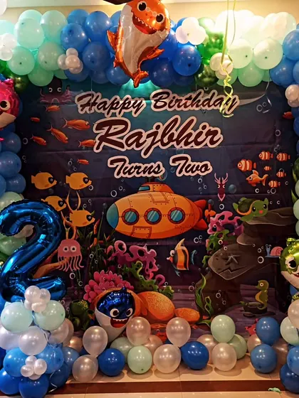 A closer look at the Baby Shark birthday backdrop, showing the vibrant underwater scene and personalized text.