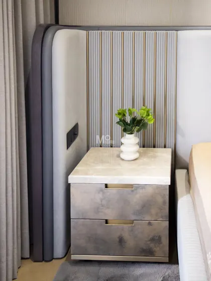 For the Suncity residence, the theme was soft modernity. This is reflected in the Monarch Bed's extended headboard, a sculptural composition of plush upholstered panels that blend clean lines with tactile warmth, creating a serene and stylish bedroom.