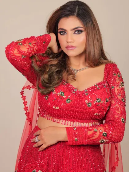 A beautiful portrait of this glamorous red look. The makeup enhances her features, giving her a powerful and confident aura.
