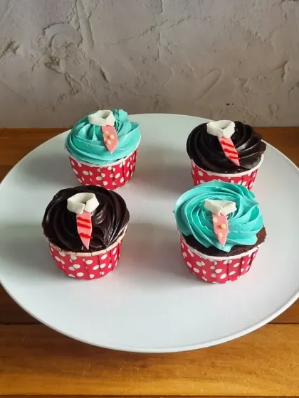 Another look at our Father's Day cupcakes, featuring chocolate and vanilla frosting with cute edible tie decorations. They are a perfect bite-sized treat for the occasion.