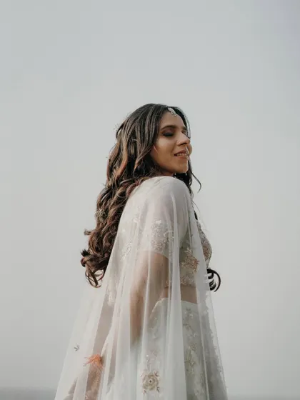 A candid shot of the bride-to-be, with a natural smile and the wind in her hair. These individual portraits are an important part of the couple's story.