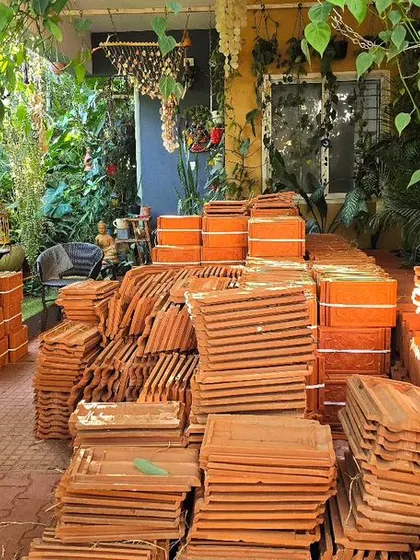 A pile of old roofing tiles waiting to be repurposed. In our garden, nothing goes to waste. These will find a new life in pathways or as decorative elements.