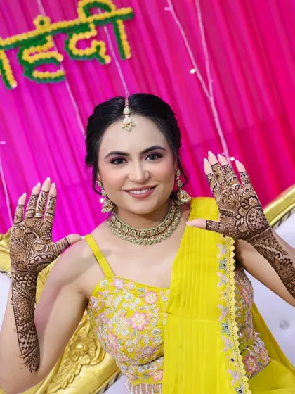 The bride showing her henna-adorned hands.