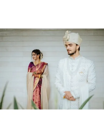 An artistic portrait with the groom in focus and the bride in the background, creating a layered composition.